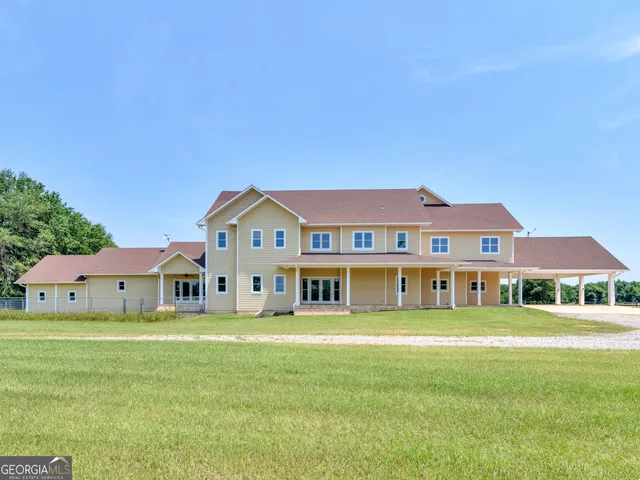 a front view of a house with a big yard