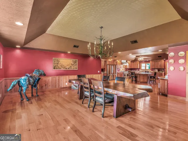 a kitchen with stainless steel appliances granite countertop a stove a refrigerator and a wooden cabinets