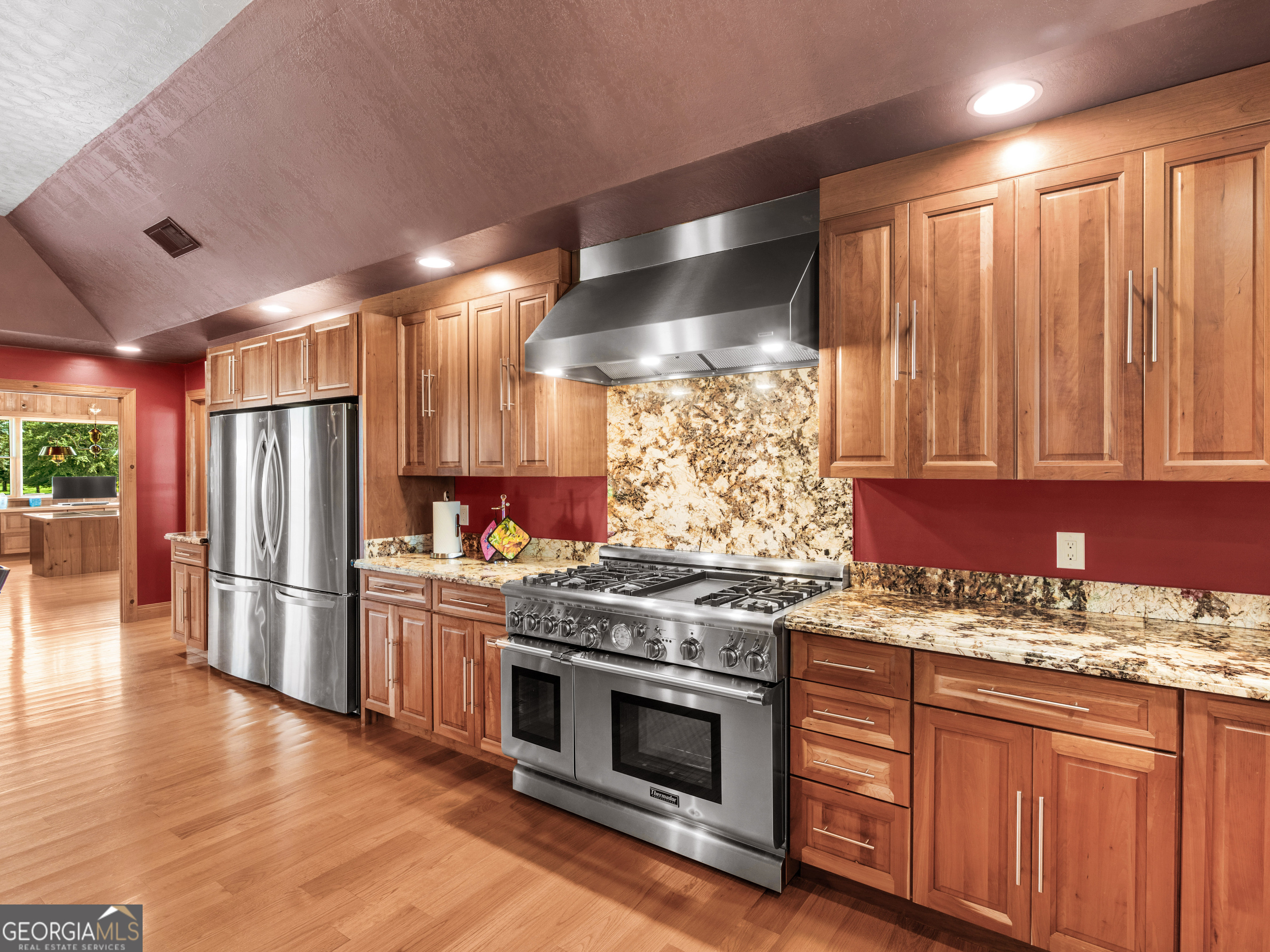 2051 Gough Road Louisville, GA 30434 - Photo 28 of 95 a kitchen with stainless steel appliances granite countertop a stove a refrigerator and a wooden cabinets