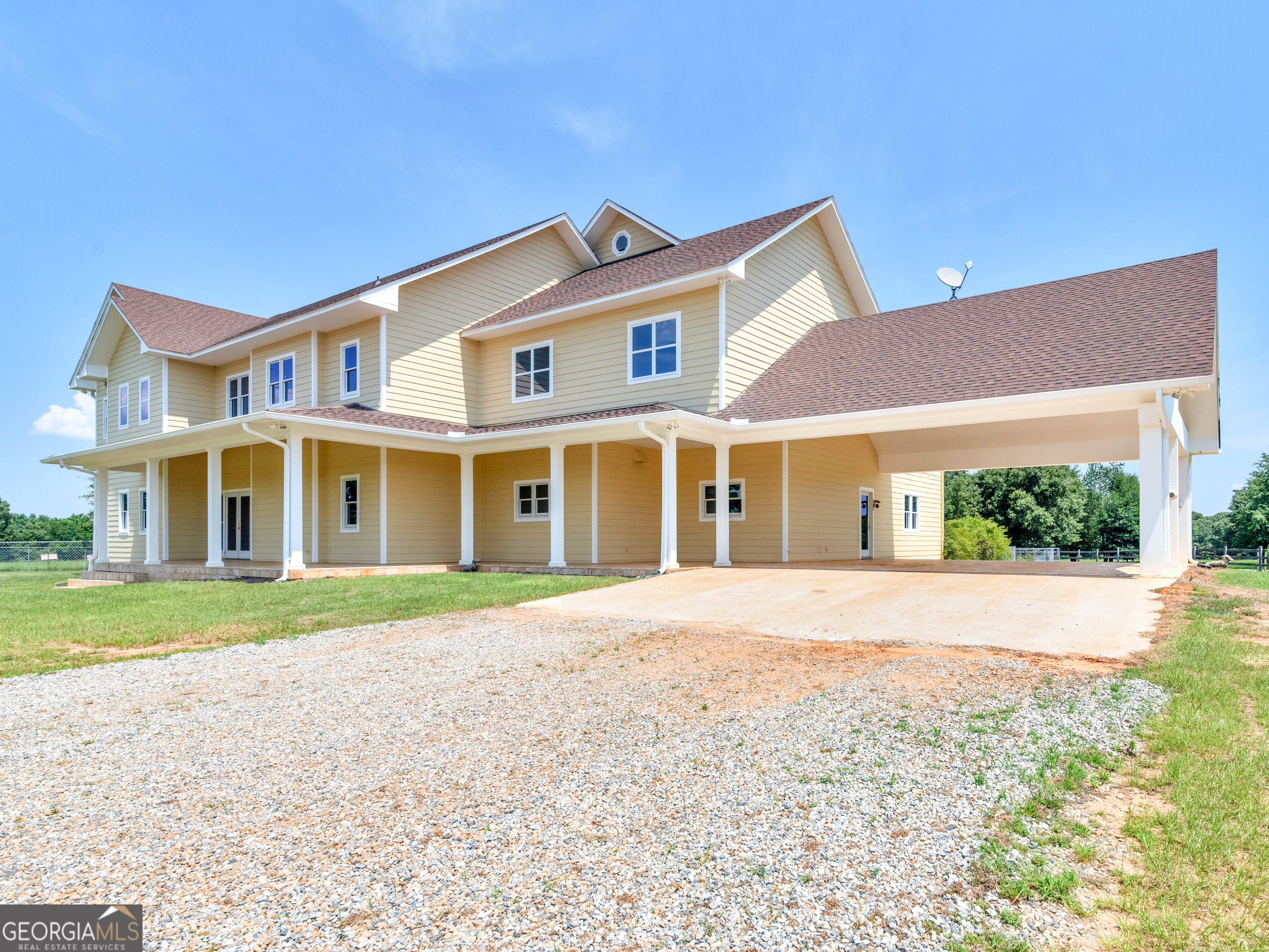 2051 Gough Road Louisville, GA 30434 - Photo 3 of 95 a front view of a house with a yard and garage
