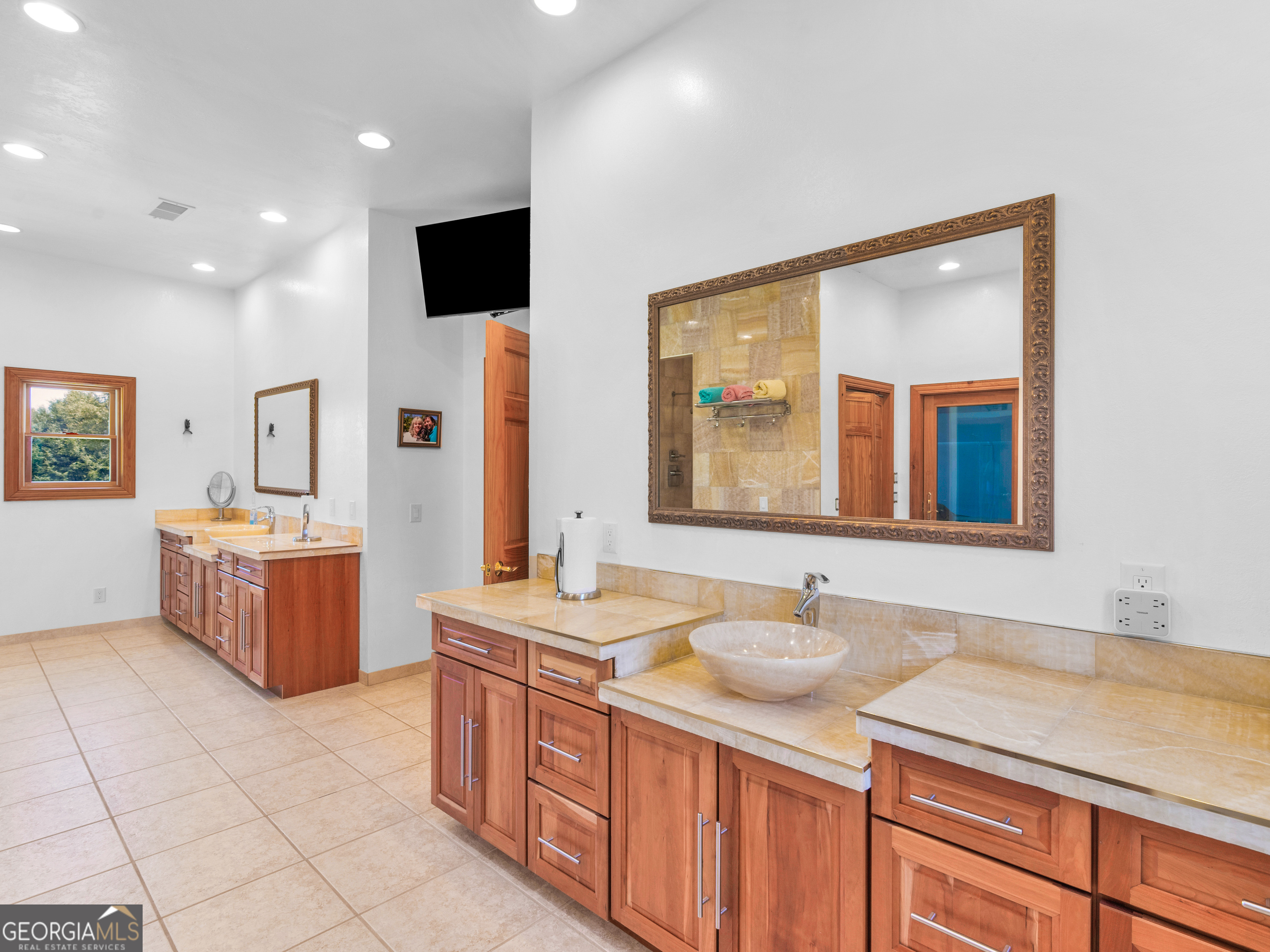 2051 Gough Road Louisville, GA 30434 - Photo 46 of 95 a bathroom with a sink double vanity and a mirror
