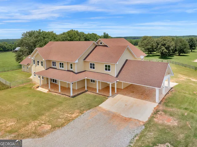 an aerial view of a house with a yard lake view and mountain view