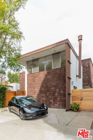 a car parked in front of a white house