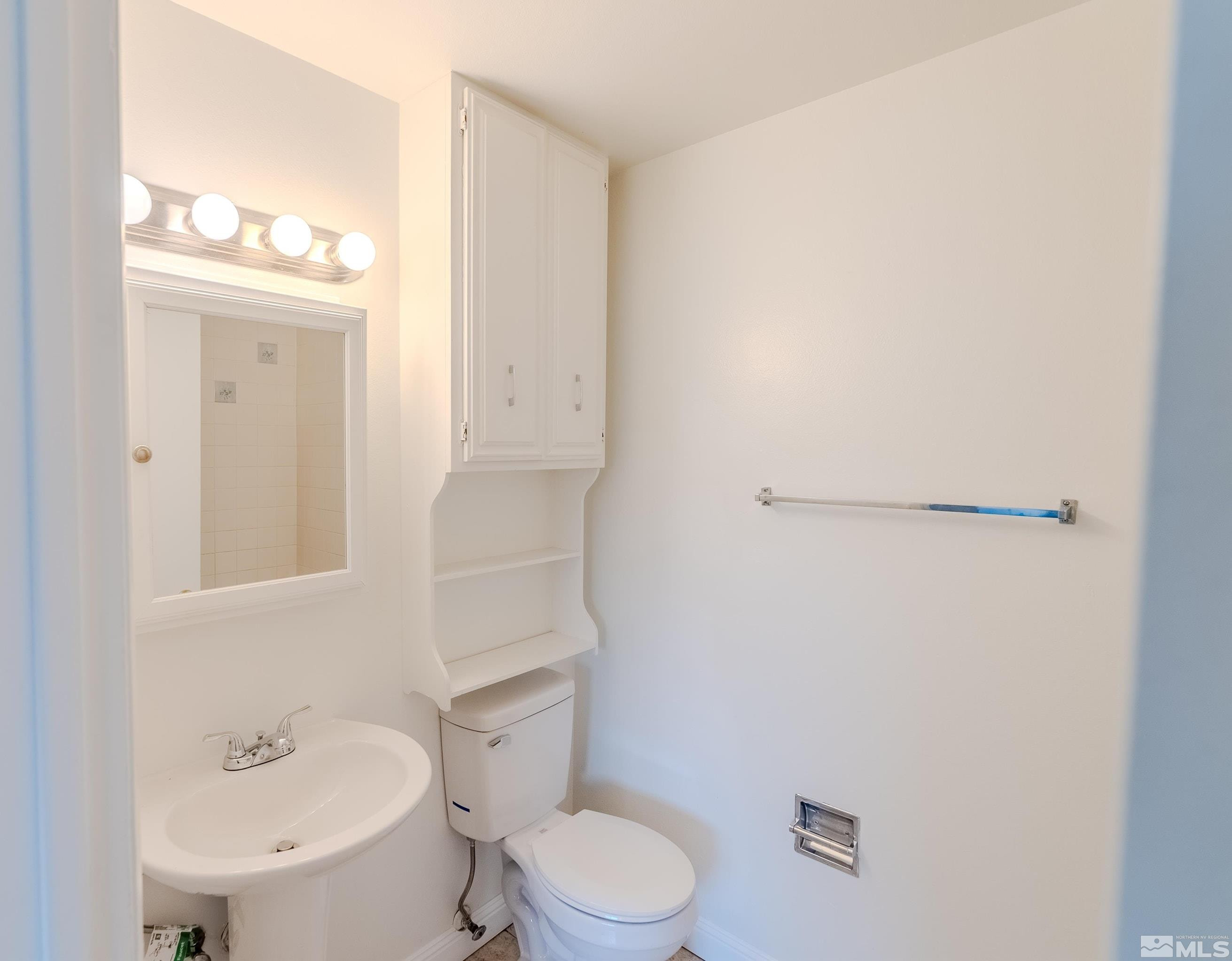 1640 Gault Way Sparks, NV 89431 - Photo 13 of 15 a white toilet sitting next to a bathroom sink