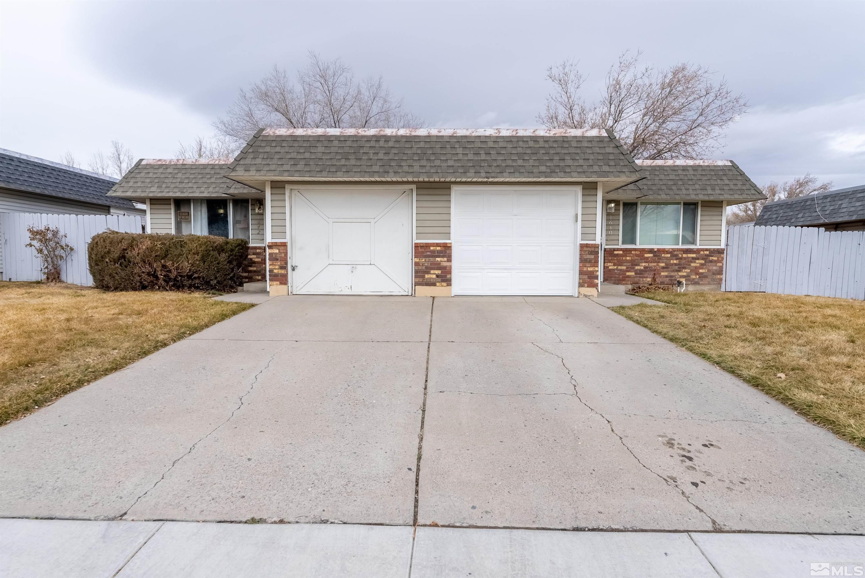 1640 Gault Way Sparks, NV 89431 - Photo 2 of 15 a front view of a house with a yard and garage