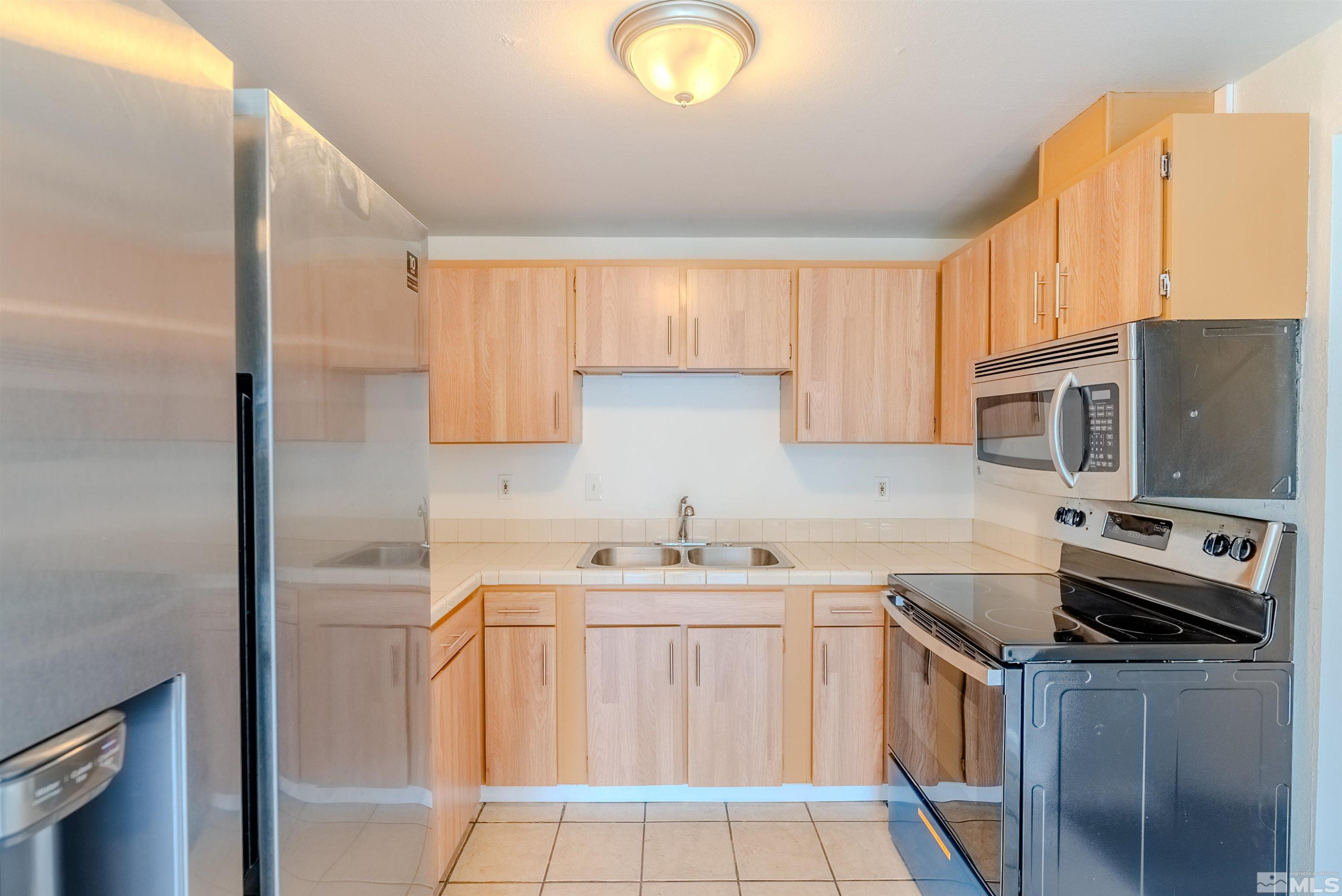 1640 Gault Way Sparks, NV 89431 - Photo 6 of 15 a kitchen with stainless steel appliances a sink stove and cabinets