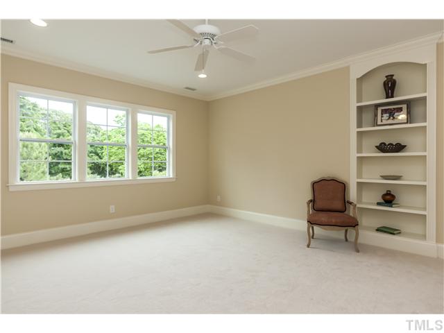 913 Keith Road Wake Forest, NC 27587 - Photo 18 of 25 Large Bonus Or Media Room With Built-in Storage. Wall Of Windows Overlooking The Private Back Yard.