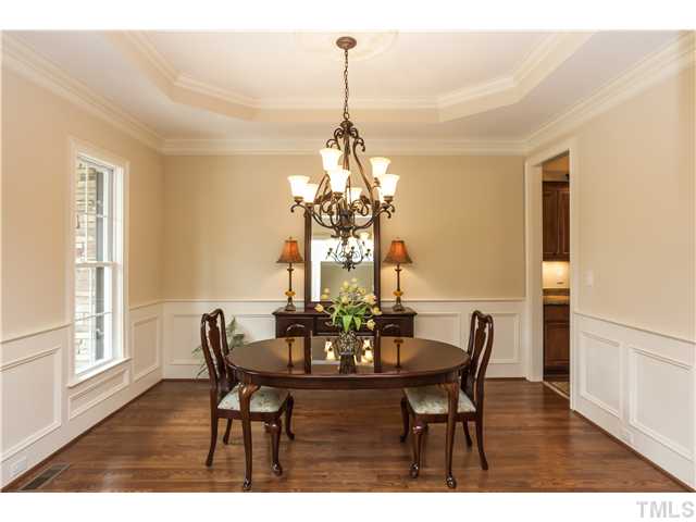 913 Keith Road Wake Forest, NC 27587 - Photo 4 of 25 You Will Love Entertaining Family And Friends In This Spacious And Beautiful Dining Room. Hardwood Floors Stained On Site, Wainscoting Details, Tray And Medalion Ceiling Accents And Designer Lighting.