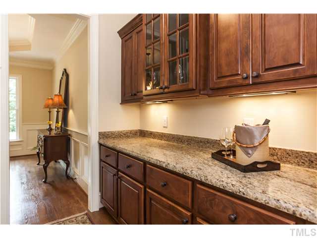 913 Keith Road Wake Forest, NC 27587 - Photo 5 of 25 Butlers Pantry Connecting Kitchen And Dining Room. Beautiful Custom Cabinets And Granite Counters. Display Your Favorite Pieces Behind The Glass Doors.