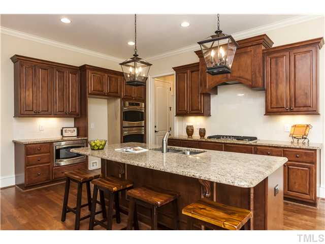 913 Keith Road Wake Forest, NC 27587 - Photo 9 of 25 Gas Cook Top, Double Oven, Built-in Microwave, Custom Tile Back Splash, Custom Cabinets, Under Cabinet Lighting, And Designer Light Fixtures. Spacious Breakfast Room With Beautiful View Of The Private Back Yard.