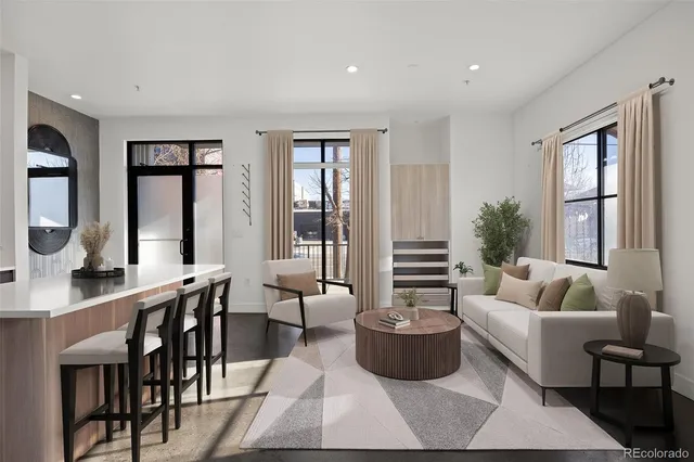 a living room with furniture and large windows