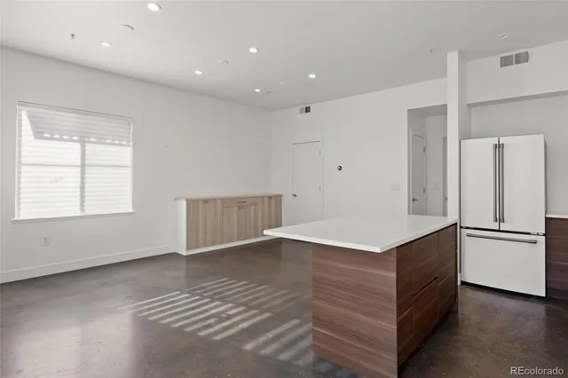 a kitchen with a refrigerator and countertop