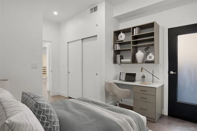 a bedroom with a bed and a closet