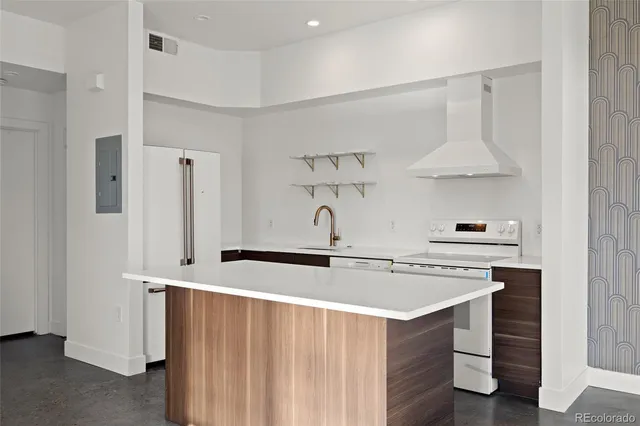 a kitchen with stainless steel appliances a sink a stove and a refrigerator
