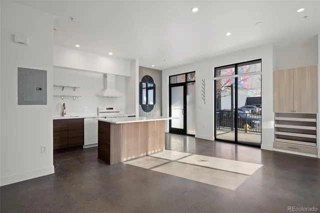 a large white kitchen with a large window