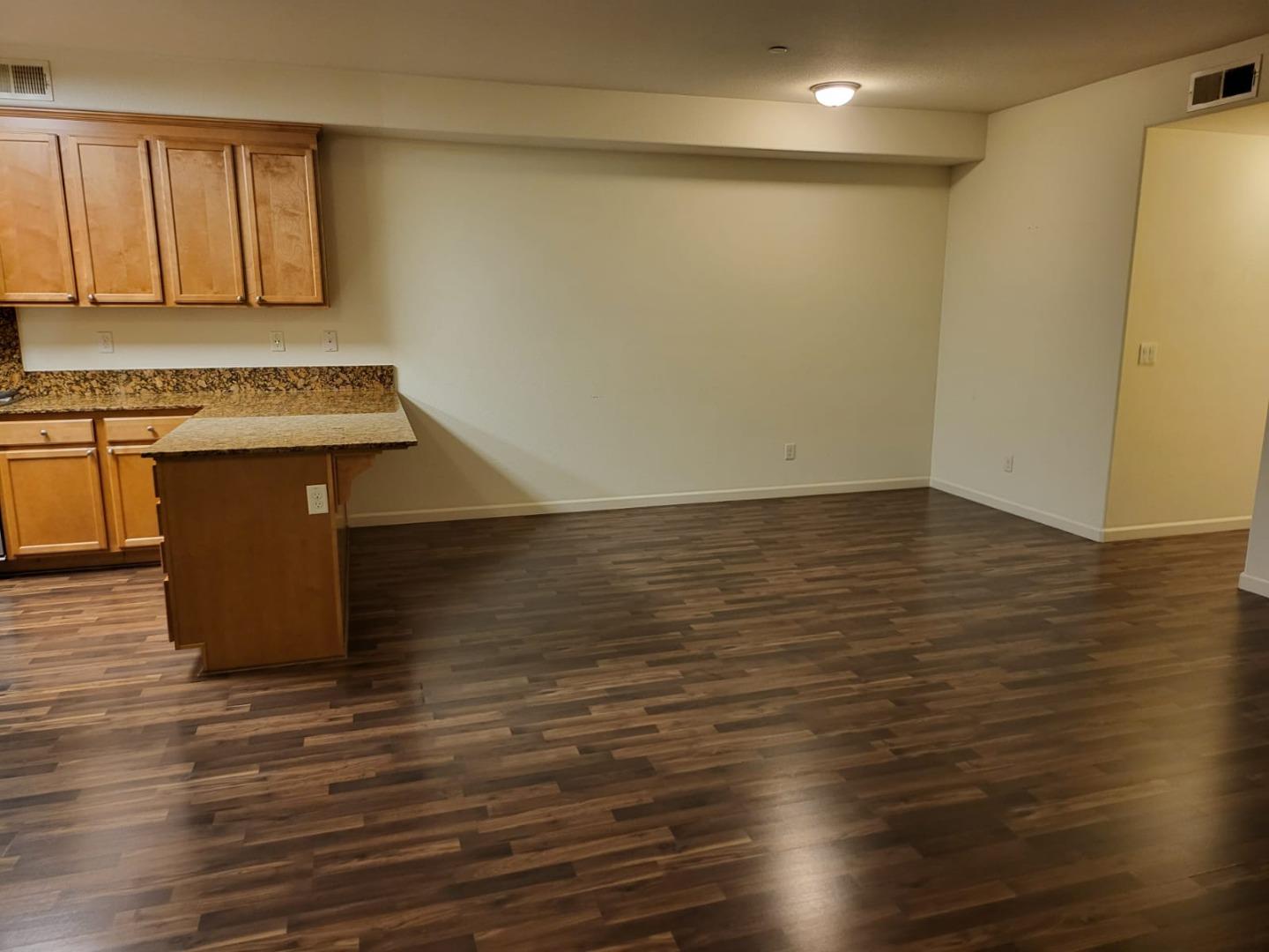 4708 Norris Canyon Road, Unit 203 San Ramon, CA 94583 - Photo 5 of 27 a view of an empty room with wooden floor and a sink