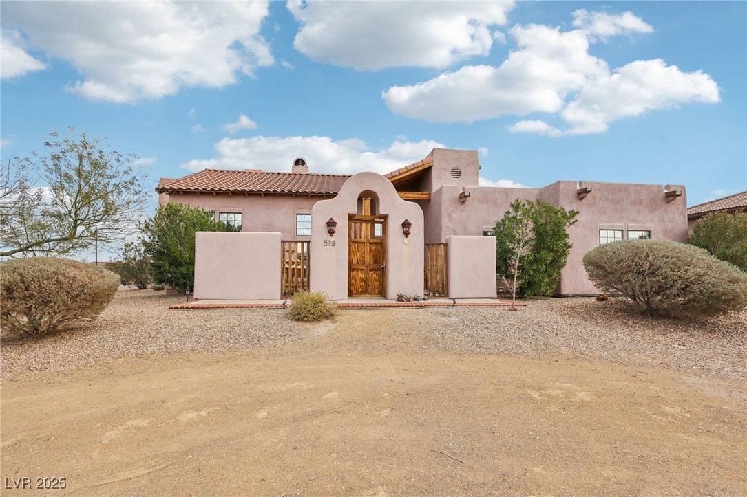 519 North Racetrack Road Henderson, NV 89015 - Photo 10 of 98 View of front of property featuring a fenced front yard, a tiled roof, a gate, stucco siding, and a chimney