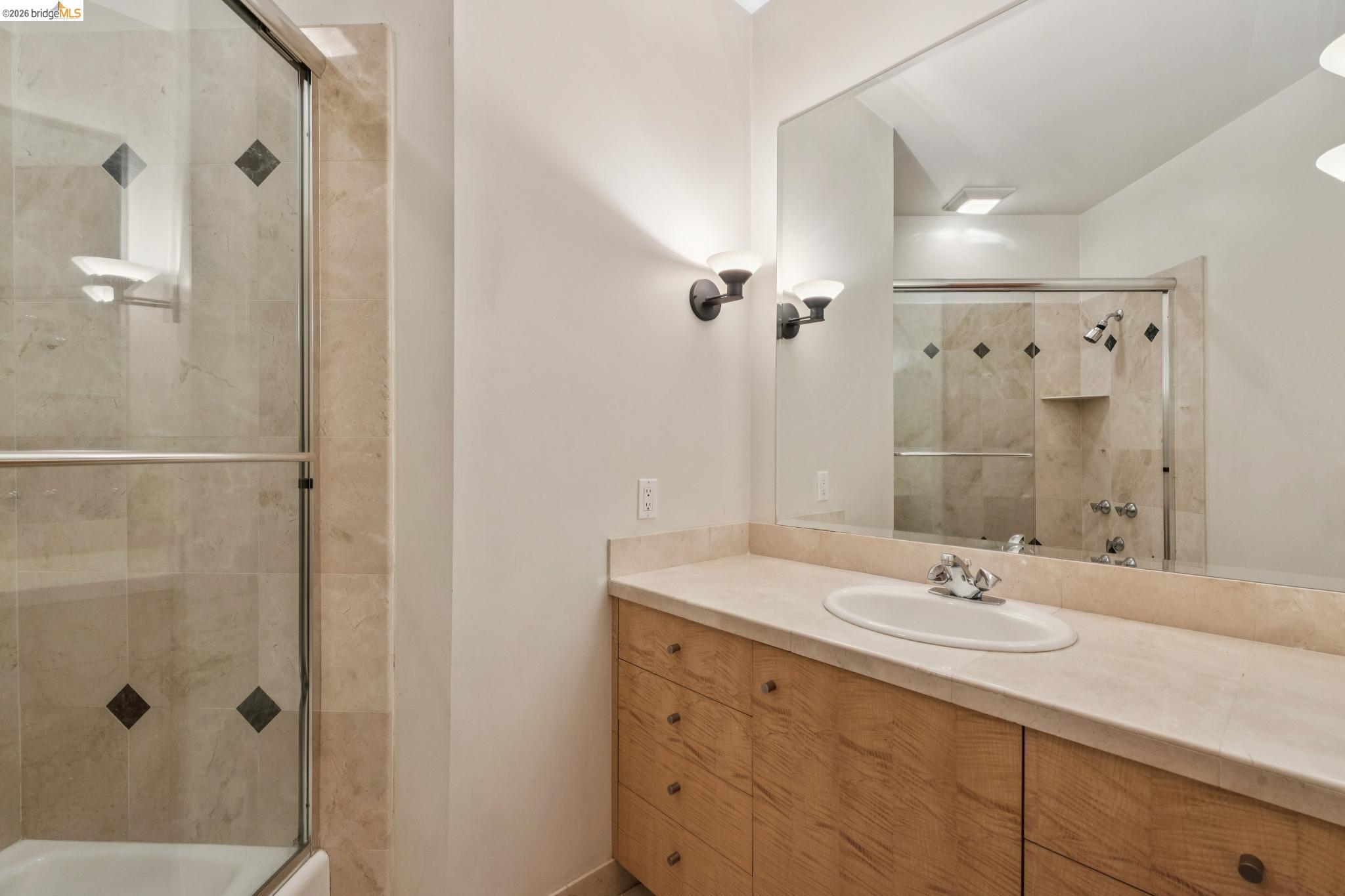 150 Vicente Road Berkeley, CA 94705 - Photo 41 of 54 a bathroom with a shower sink and mirror