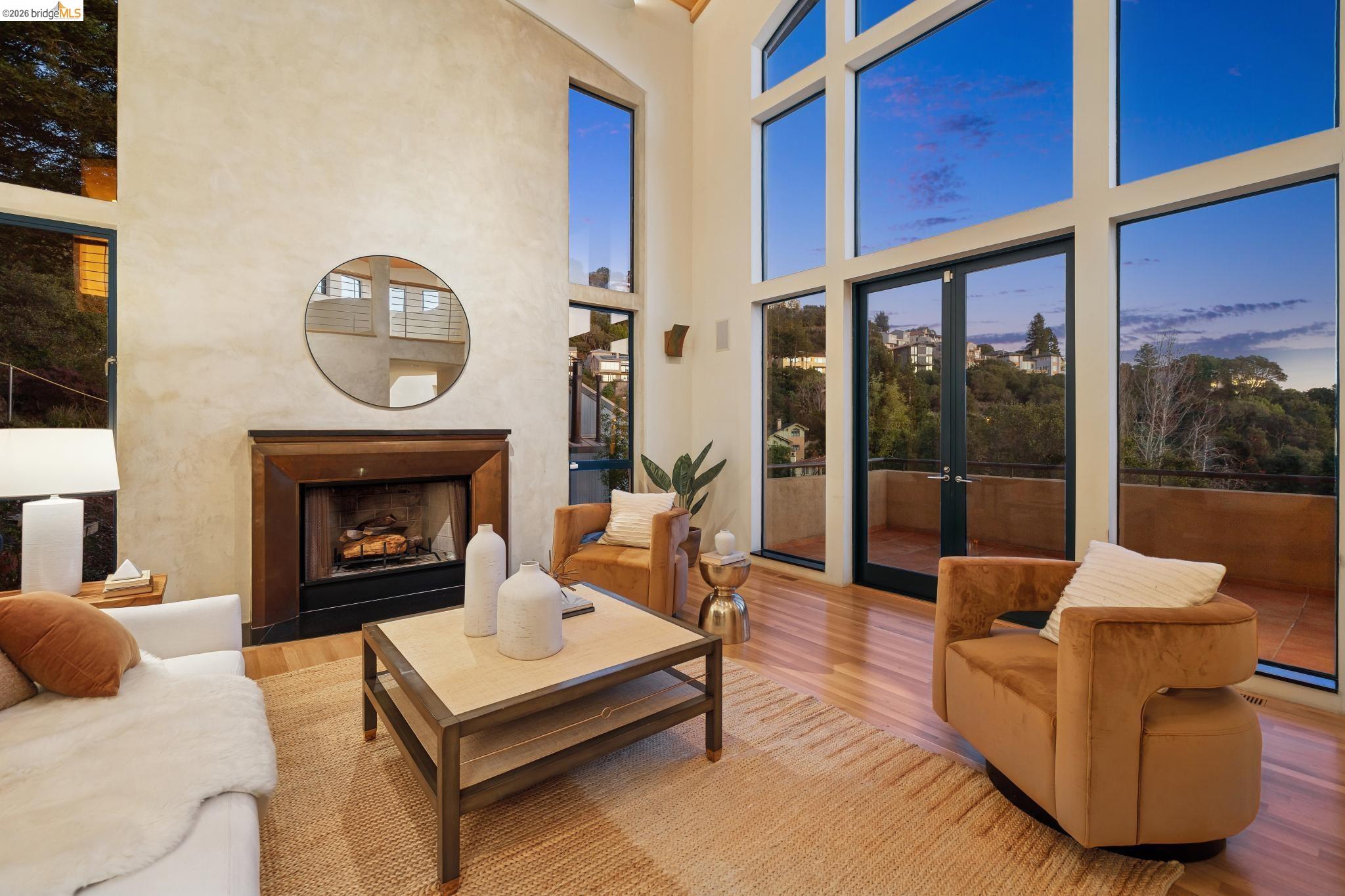 150 Vicente Road Berkeley, CA 94705 - Photo 48 of 54 a living room with furniture a fireplace and a floor to ceiling window