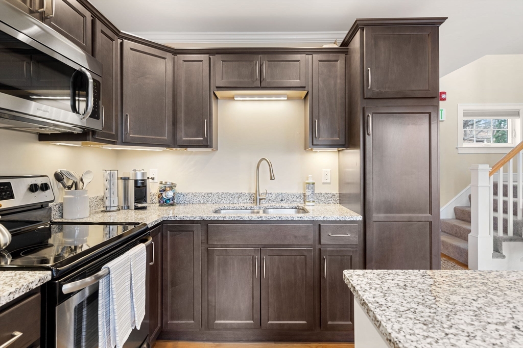 48 Boston Road, Unit A Groton, MA 01450 - Photo 11 of 22 a kitchen with stainless steel appliances granite countertop a sink stove and refrigerator