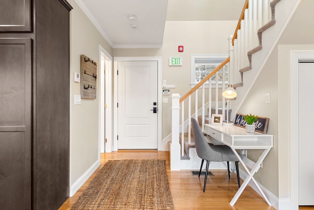 48 Boston Road, Unit A Groton, MA 01450 - Photo 13 of 22 a view of entryway dining room and hall with wooden floor