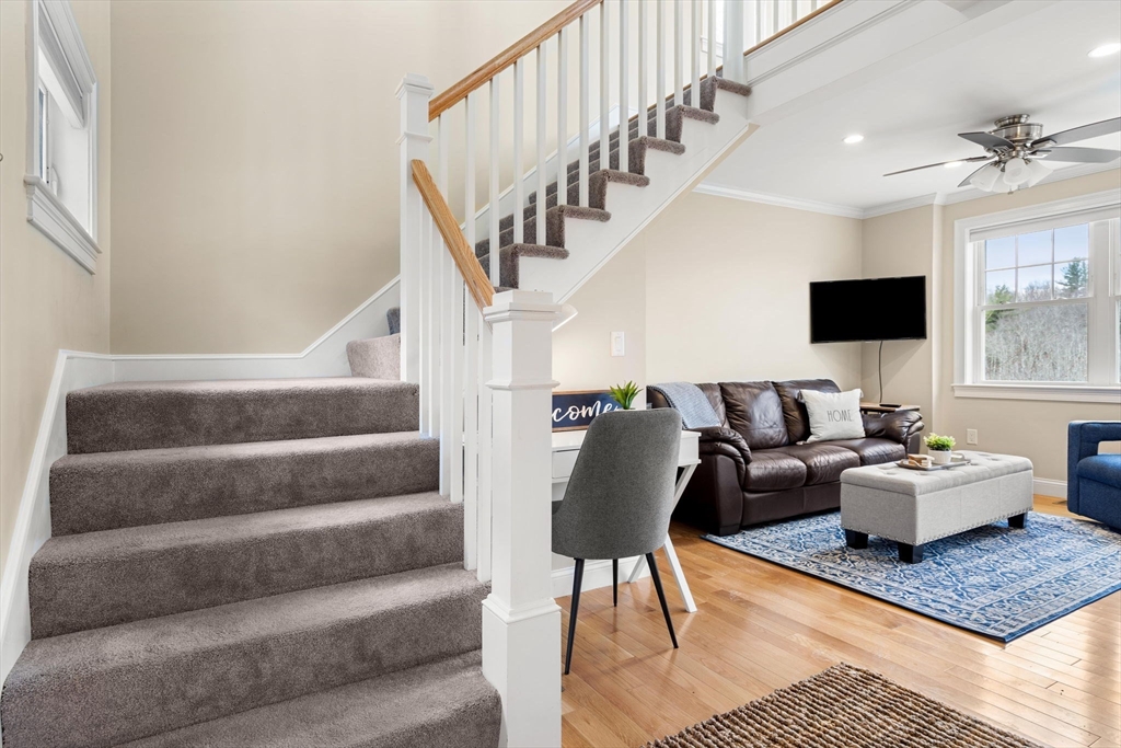 48 Boston Road, Unit A Groton, MA 01450 - Photo 16 of 22 a living room with furniture and a rug