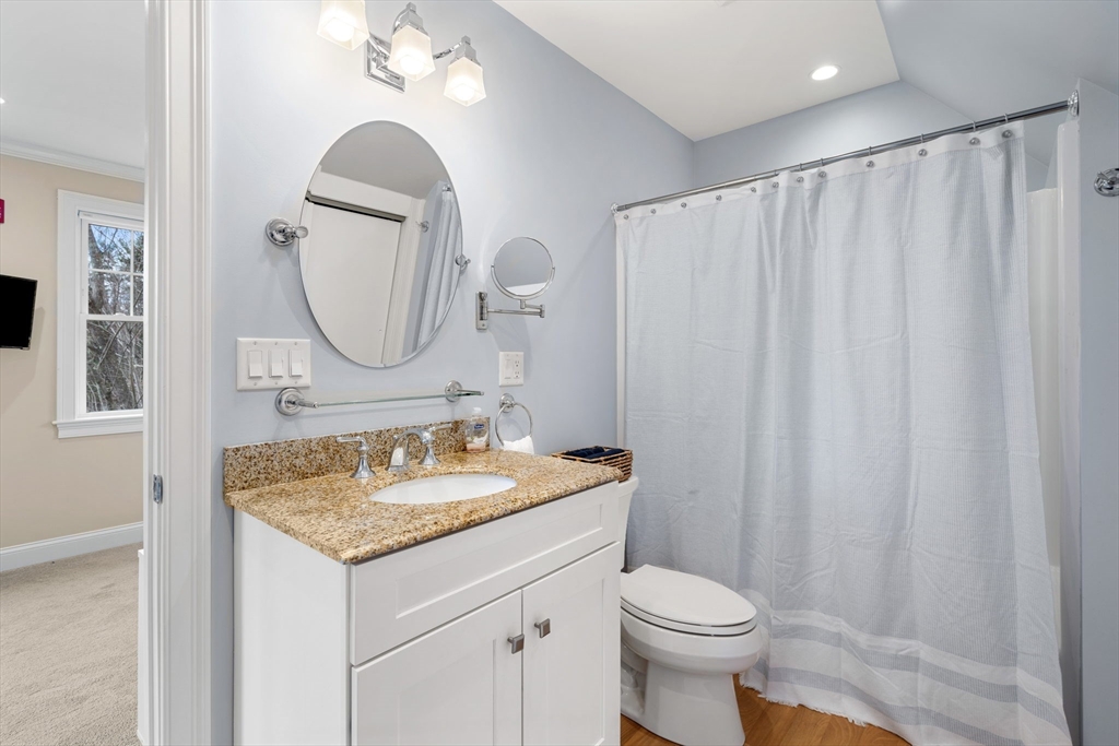 48 Boston Road, Unit A Groton, MA 01450 - Photo 18 of 22 a bathroom with a granite countertop sink and a mirror