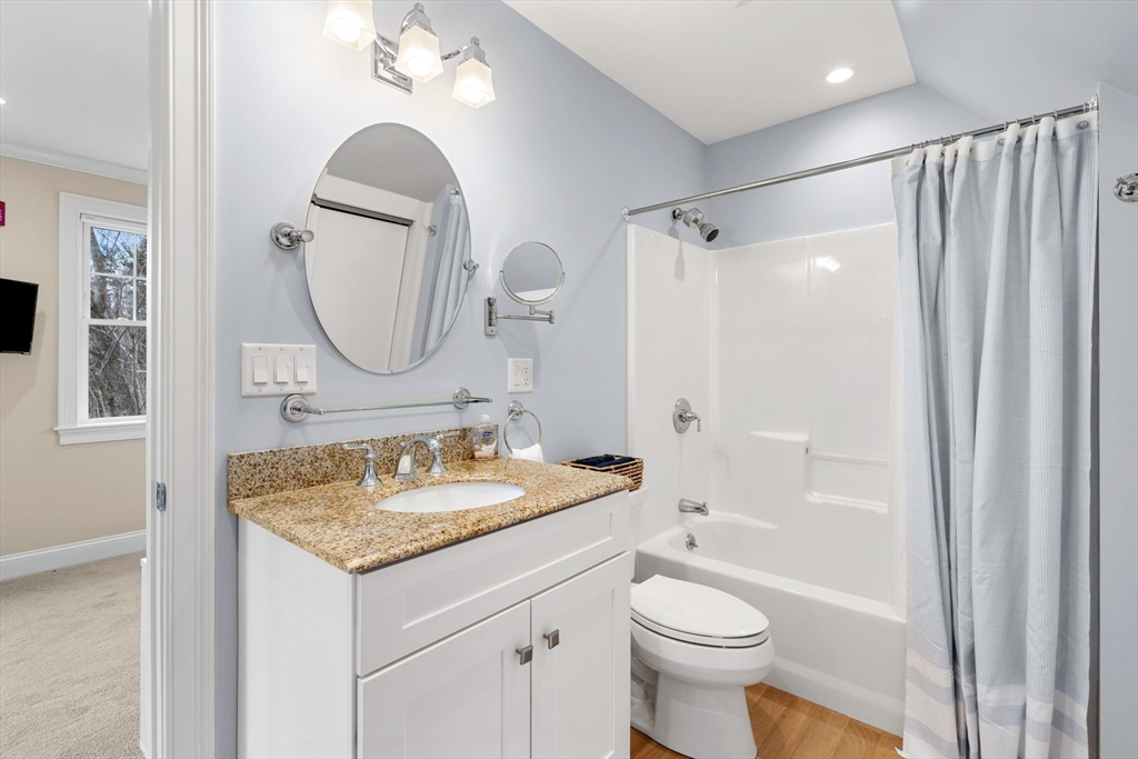 48 Boston Road, Unit A Groton, MA 01450 - Photo 19 of 22 a bathroom with a granite countertop sink toilet and shower