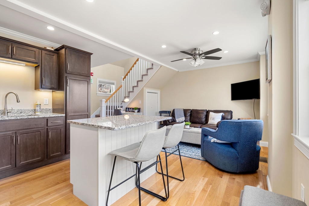 48 Boston Road, Unit A Groton, MA 01450 - Photo 2 of 22 a living room with furniture and a chandelier