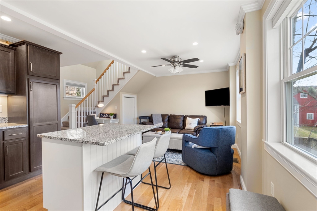 48 Boston Road, Unit A Groton, MA 01450 - Photo 3 of 22 a living room with furniture and a flat screen tv