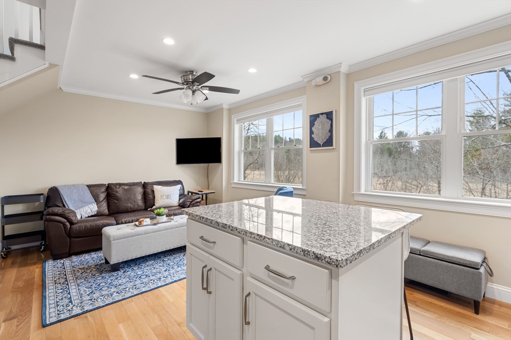 48 Boston Road, Unit A Groton, MA 01450 - Photo 4 of 22 a living room with granite countertop furniture and fireplace