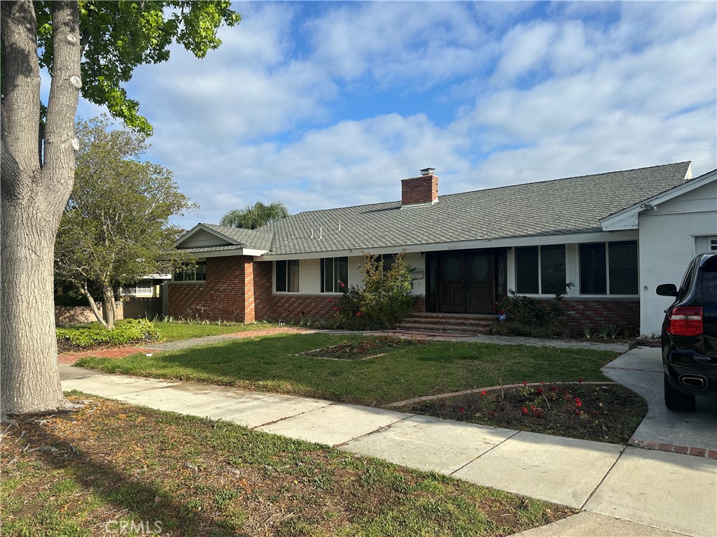3025 East Hillcrest Avenue Orange, CA 92867 - Photo 1 of 6 a front view of a house with a yard