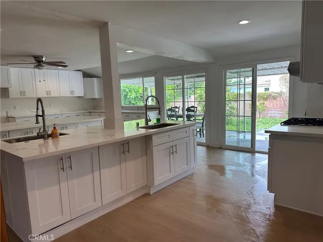 a kitchen with a sink and white cabinets