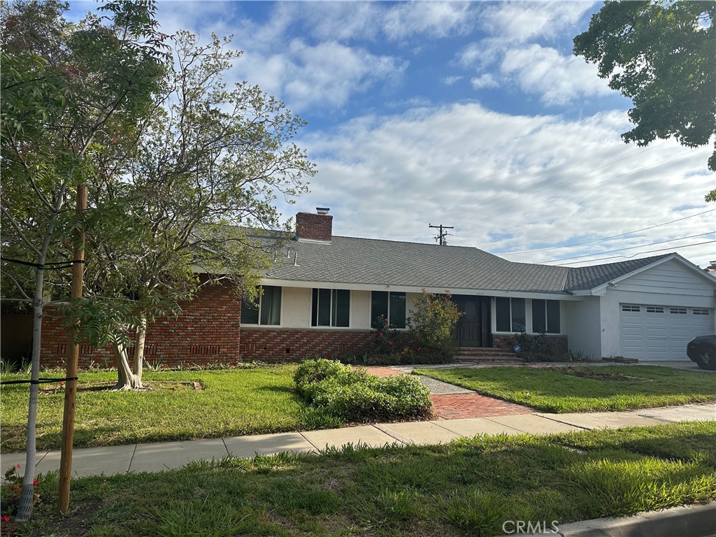 3025 East Hillcrest Avenue Orange, CA 92867 - Photo 5 of 6 a front view of a house with a yard