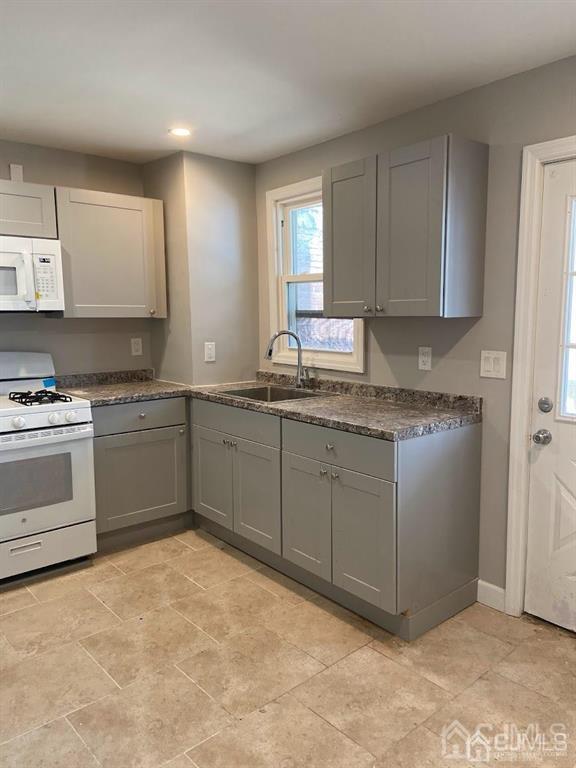 a kitchen with a stove a sink and a window
