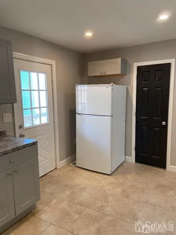 a kitchen with a refrigerator and a sink