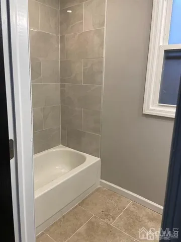 a white bath tub sitting next to a window