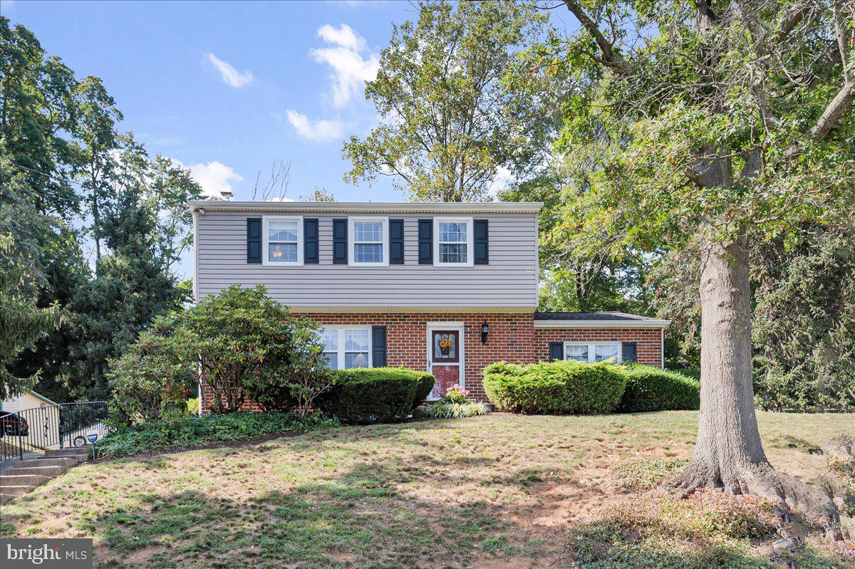 2575 West Colonial Drive Upper Chichester, PA 19061 - Photo 1 of 42 a front view of a house with a yard and trees