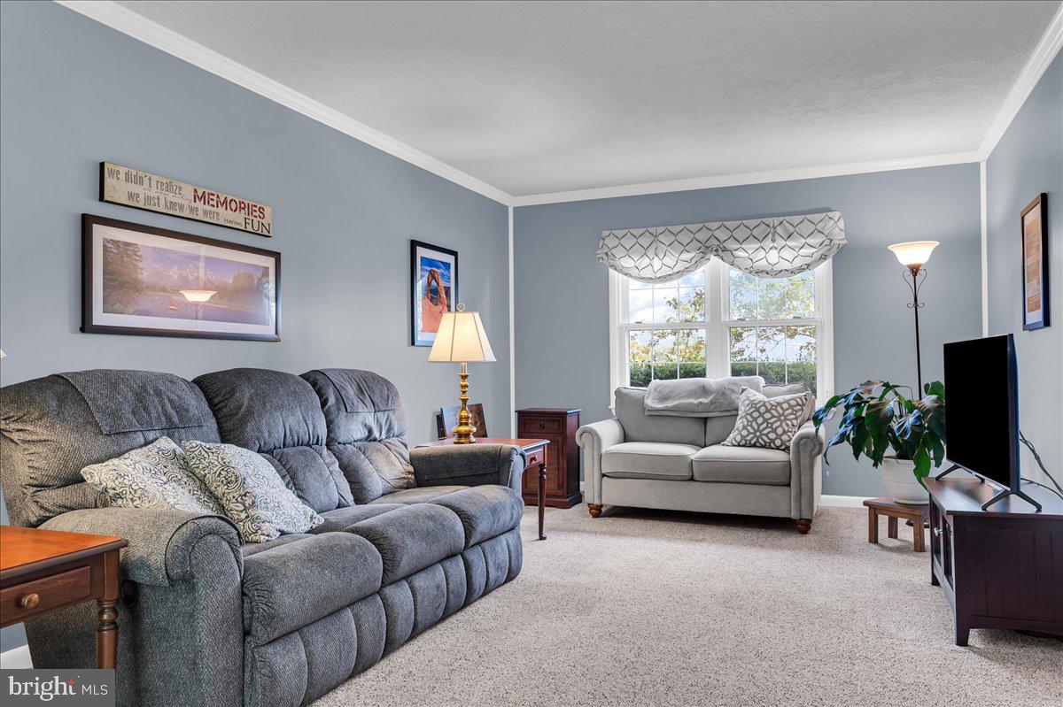 2575 West Colonial Drive Upper Chichester, PA 19061 - Photo 13 of 42 a living room with furniture flat screen tv and windows