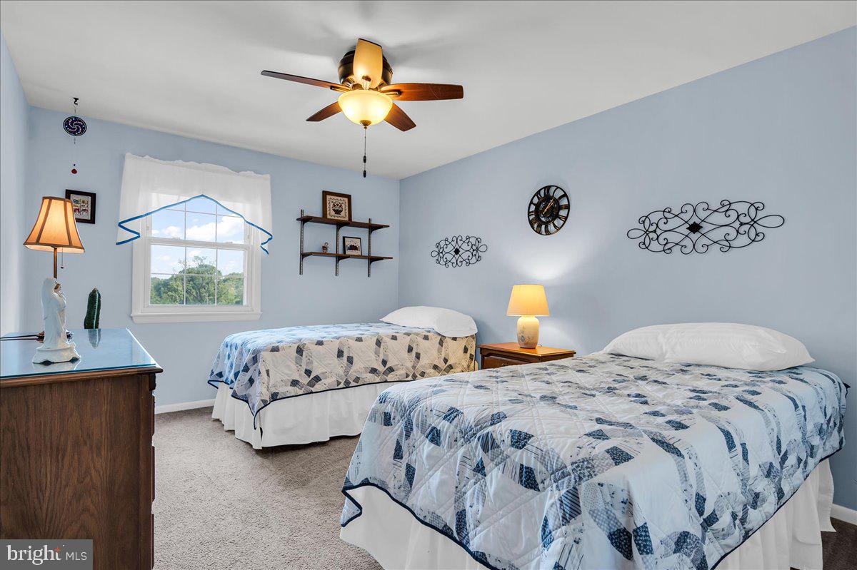 2575 West Colonial Drive Upper Chichester, PA 19061 - Photo 22 of 42 a bedroom with two beds and a chandelier