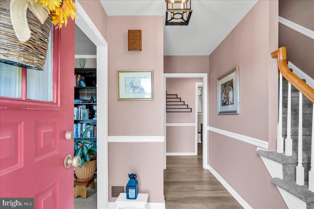 2575 West Colonial Drive Upper Chichester, PA 19061 - Photo 4 of 42 a view of a hallway with wooden floor and a potted plant