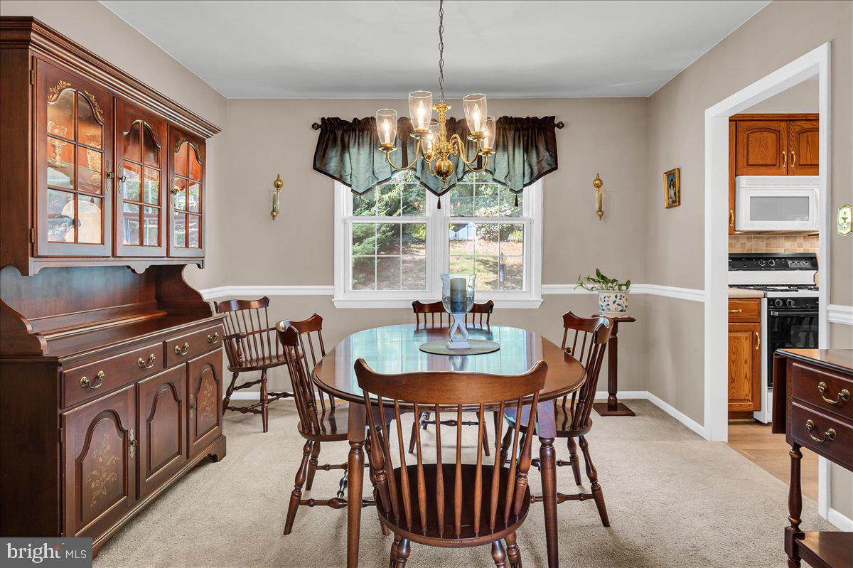 2575 West Colonial Drive Upper Chichester, PA 19061 - Photo 6 of 42 a dining room with furniture a chandelier and window