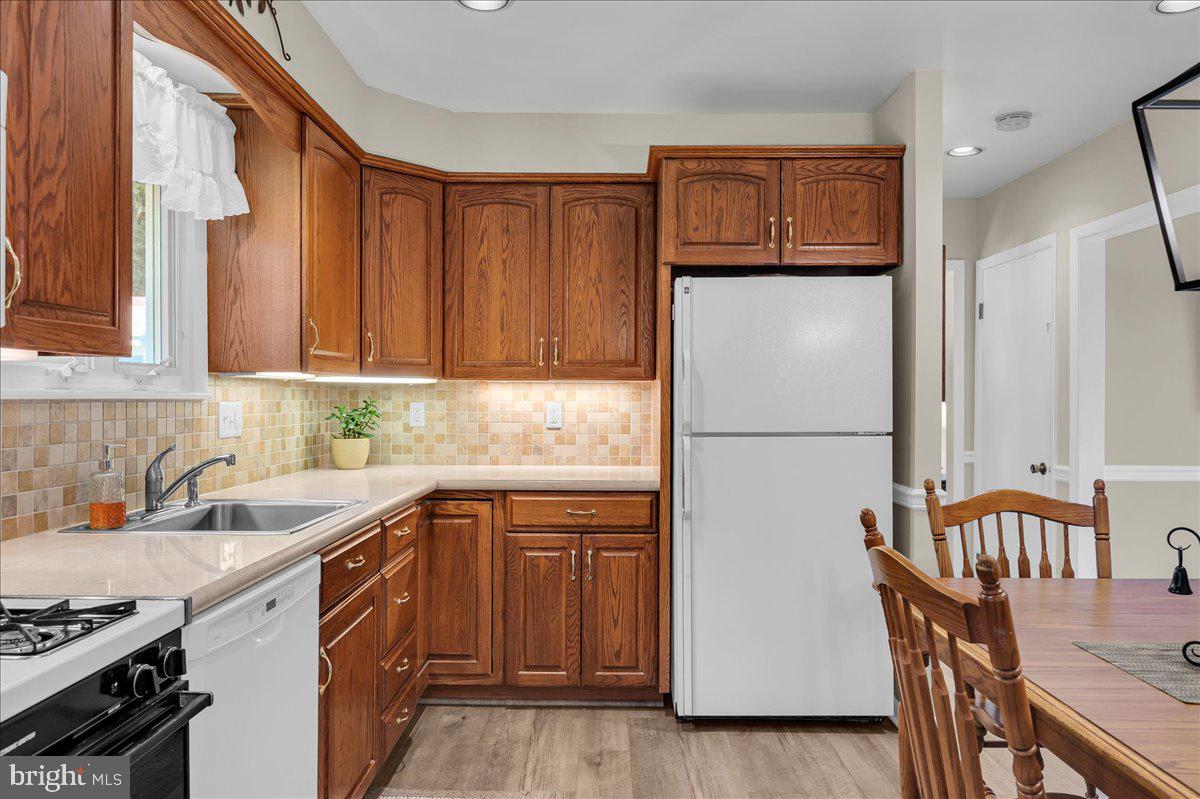 2575 West Colonial Drive Upper Chichester, PA 19061 - Photo 9 of 42 a kitchen with a sink a refrigerator and wooden cabinets