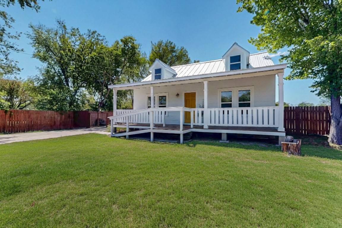 a view of a house with a yard and deck