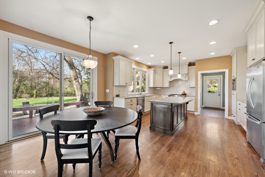 4N698 High Meadow Road St. Charles, IL 60175 - Photo 8 of 39 a kitchen with stainless steel appliances granite countertop a stove a refrigerator a kitchen island a table and chairs