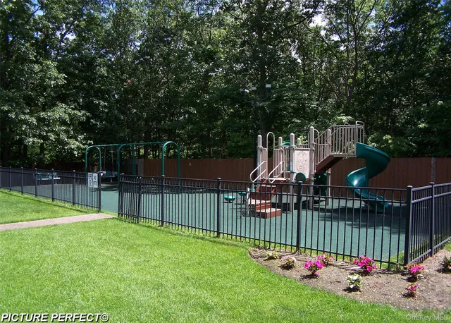 a view of a garden with wooden fence
