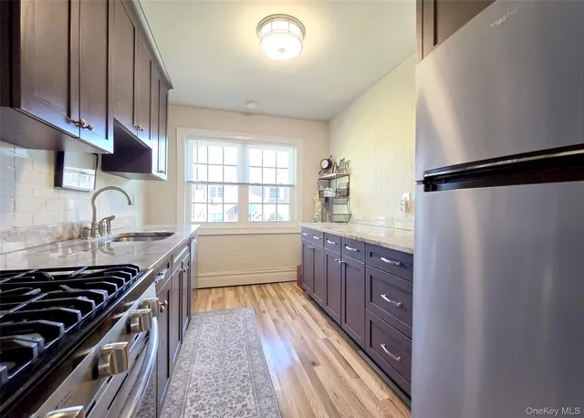 a kitchen with granite countertop a stove and a sink