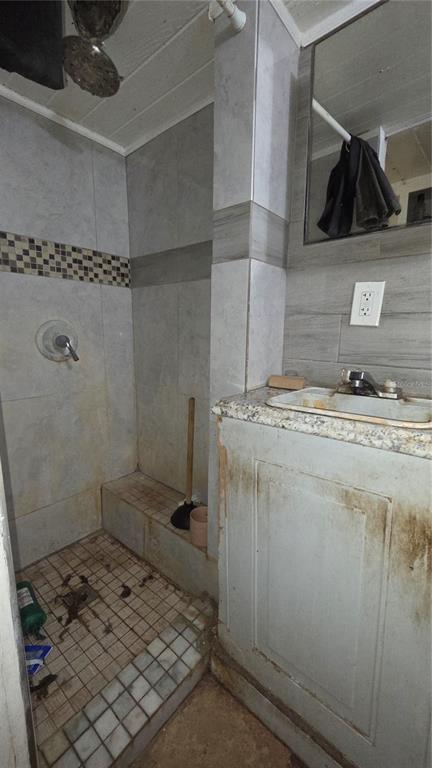 3000 Clarcona Road, Unit 510 Apopka, FL 32703 - Photo 8 of 8 a bathroom with a granite countertop sink a mirror and shower