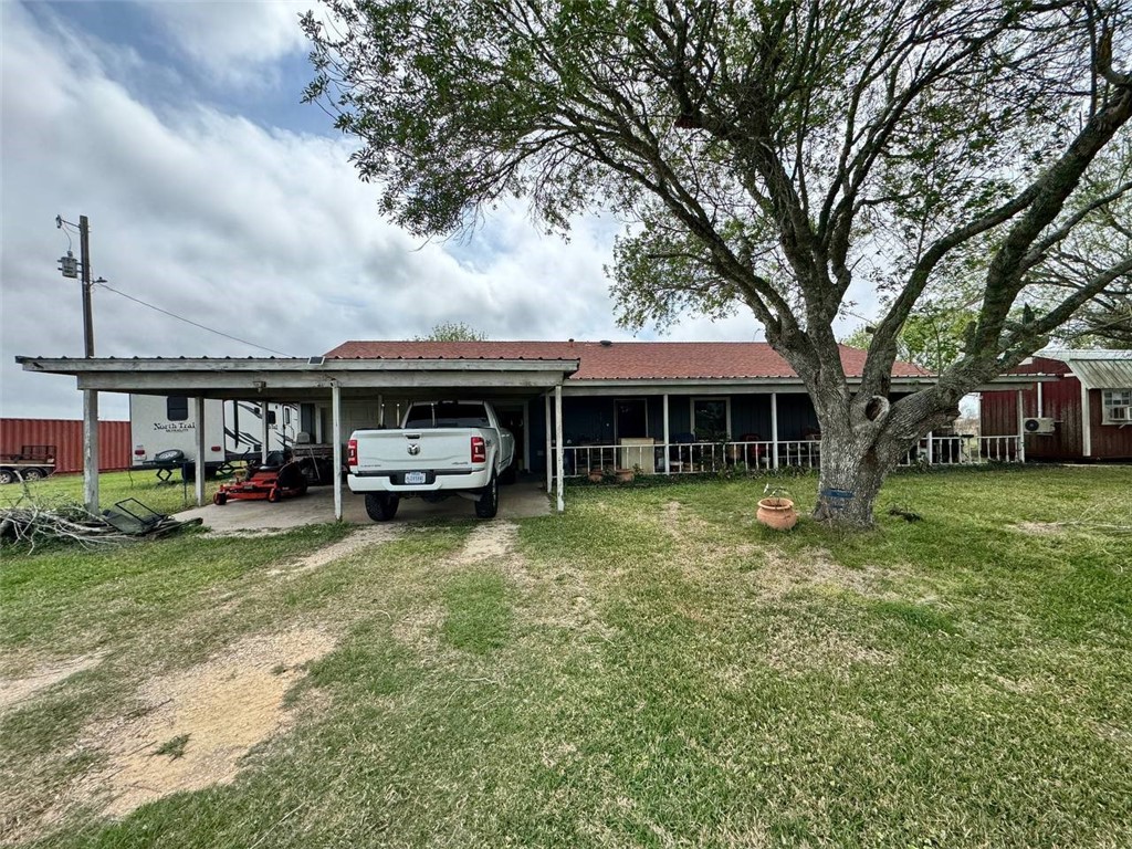 350 Quail Meadow Road Seadrift, TX 77983 - Photo 1 of 22 a car parked in front of a house next to a yard