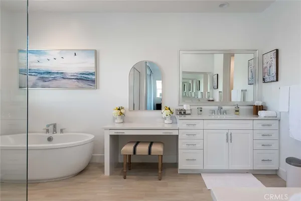 a bathroom with a white tub sink and vanity